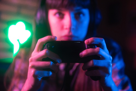 Young woman addicted to playing a video game.